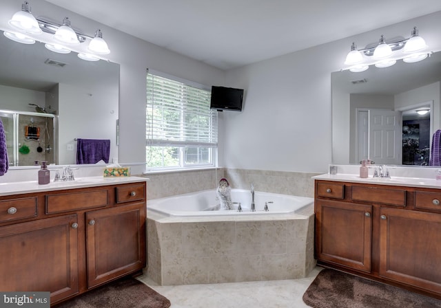 3317 Eagle Ridge Dr, Woodbridge, VA 22191 - full bathroom featuring tile patterned flooring, two vanities, a garden tub, and a stall shower