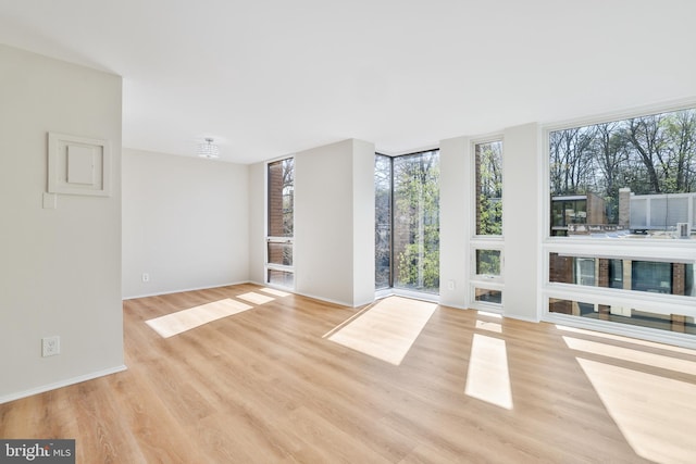 1602 Chimney House Rd Unit 1602, Reston, VA 20190 - unfurnished room featuring light wood-style floors, baseboards, and expansive windows