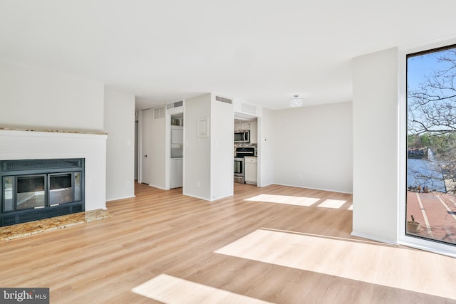 1602 Chimney House Rd Unit 1602, Reston, VA 20190 - unfurnished living room featuring light wood finished floors and a glass covered fireplace