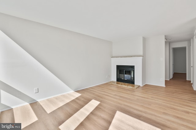 1602 Chimney House Rd Unit 1602, Reston, VA 20190 - unfurnished living room with a glass covered fireplace, light wood-style flooring, and baseboards