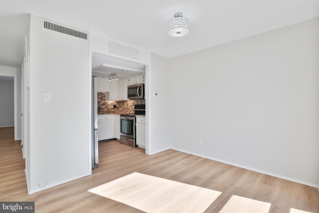 1602 Chimney House Rd Unit 1602, Reston, VA 20190 - unfurnished living room with light wood-type flooring and baseboards