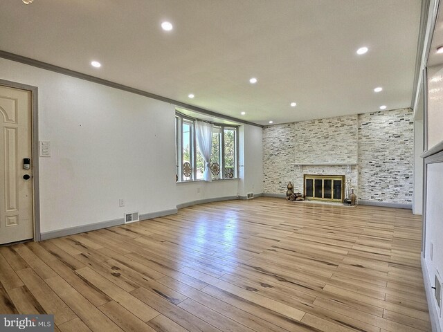 1927 N 15th St, Reading, PA 19604 - unfurnished living room featuring ornamental molding, recessed lighting, light wood-style flooring, baseboards, and a fireplace