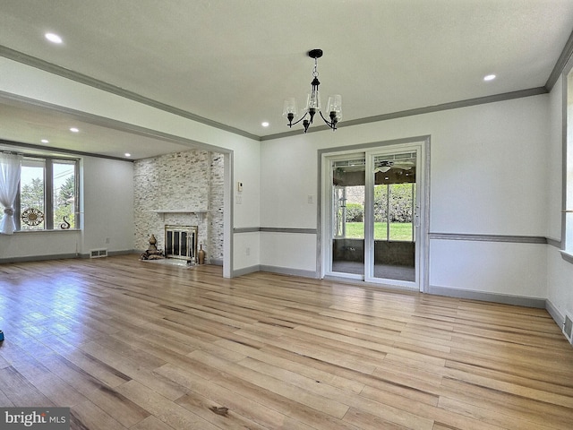 1927 N 15th St, Reading, PA 19604 - unfurnished living room featuring plenty of natural light, a chandelier, ornamental molding, baseboards, and light wood-style flooring