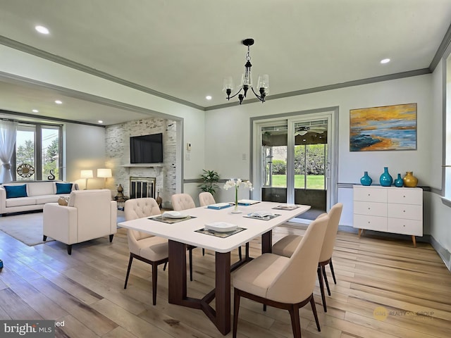 1927 N 15th St, Reading, PA 19604 - dining space with healthy amount of natural light, ornamental molding, a chandelier, light wood-style floors, and a fireplace