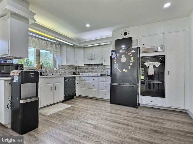 1927 N 15th St, Reading, PA 19604 - kitchen featuring black appliances, exhaust hood, light wood finished floors, recessed lighting, and decorative backsplash