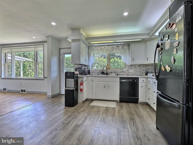 1927 N 15th St, Reading, PA 19604 - kitchen featuring black appliances, a sink, light wood-style flooring, backsplash, and white cabinetry
