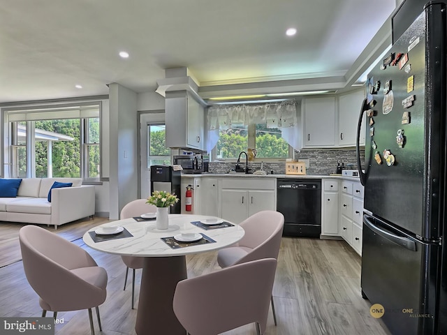 1927 N 15th St, Reading, PA 19604 - kitchen with black appliances, a sink, tasteful backsplash, light wood finished floors, and recessed lighting