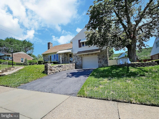 1927 N 15th St, Reading, PA 19604 - view of front of home featuring stone siding, asphalt driveway, a front lawn, an attached garage, and a chimney