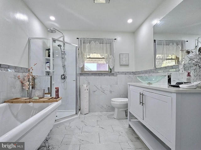 1927 N 15th St, Reading, PA 19604 - bathroom with tile walls, marble look tile flooring, a shower stall, a freestanding tub, and vanity