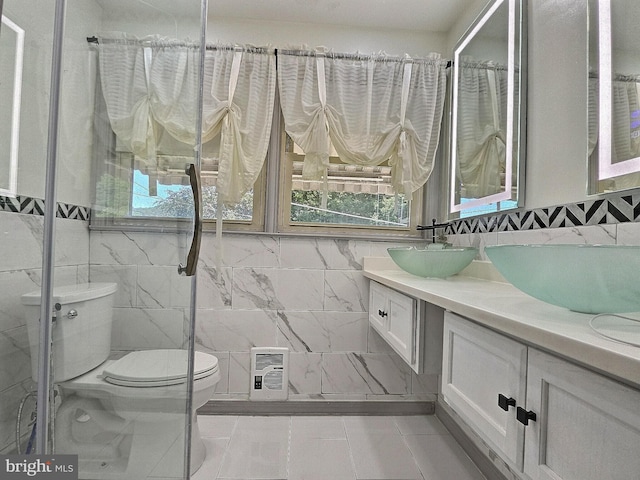 1927 N 15th St, Reading, PA 19604 - bathroom featuring toilet, double vanity, tile walls, a shower, and tile patterned floors