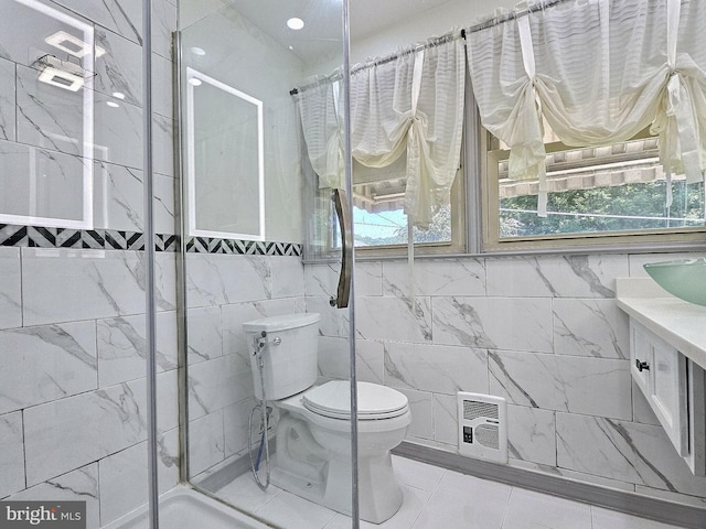 1927 N 15th St, Reading, PA 19604 - bathroom with tile walls, toilet, a stall shower, vanity, and tile patterned floors