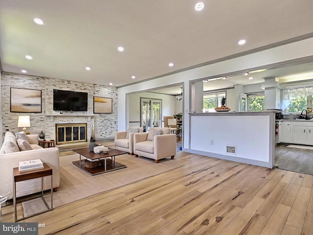 1927 N 15th St, Reading, PA 19604 - living room with light wood-style floors, ornamental molding, a fireplace, recessed lighting, and baseboards