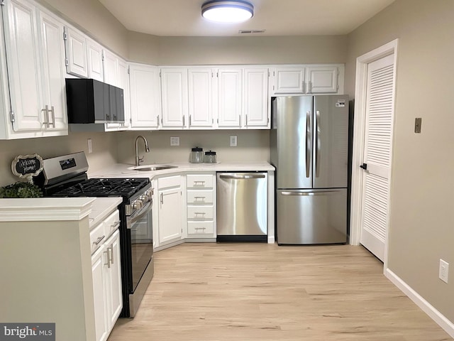 6 Kent Pl, Sewell, NJ 08080 - kitchen with stainless steel appliances, a sink, white cabinetry, and light wood finished floors