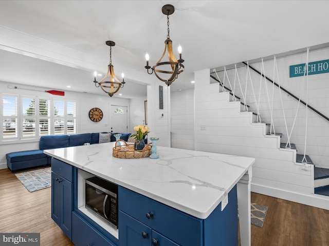 65 W W Ave W, Ocean View, DE 19970 - kitchen with black microwave, blue cabinetry, open floor plan, wood finished floors, and recessed lighting