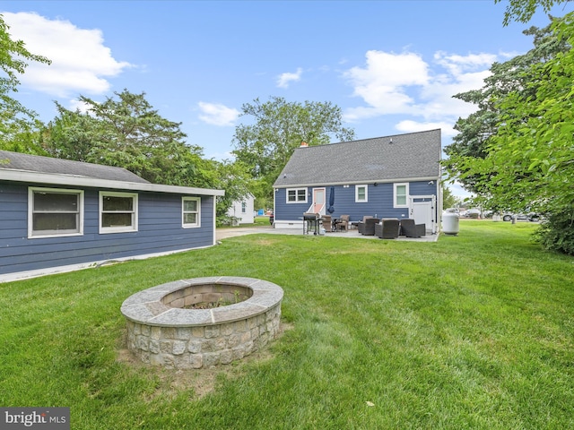 65 W W Ave W, Ocean View, DE 19970 - rear view of house with an outdoor living space with a fire pit, a patio, and a yard