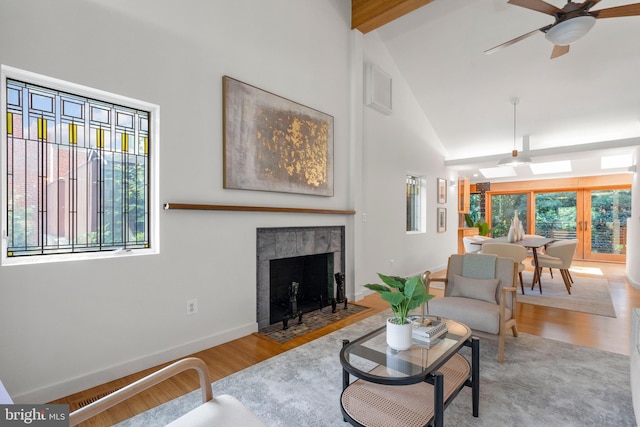 4834 8th St S, Arlington, VA 22204 - living area featuring wood finished floors, high vaulted ceiling, a ceiling fan, a tiled fireplace, and baseboards