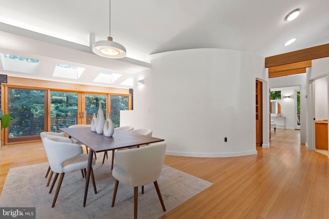 4834 8th St S, Arlington, VA 22204 - dining space featuring a skylight, light wood-type flooring, and baseboards