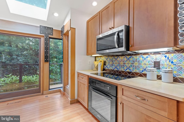 4834 8th St S, Arlington, VA 22204 - kitchen featuring black appliances, light wood-type flooring, tasteful backsplash, light countertops, and recessed lighting