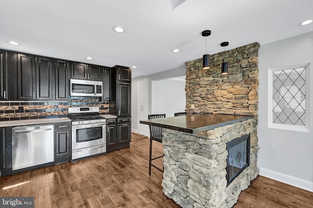 501 Clays Ln, Laurel, MD 20707 - kitchen featuring appliances with stainless steel finishes, dark cabinetry, baseboards, dark wood-style flooring, and tasteful backsplash