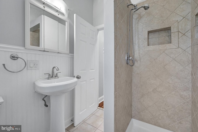 501 Clays Ln, Laurel, MD 20707 - bathroom featuring tiled shower, wainscoting, and tile patterned floors