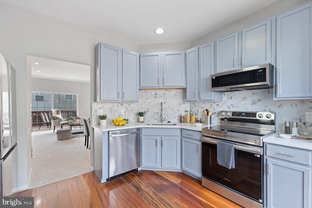 8311 Cloud St, Laurel, MD 20724 - kitchen featuring appliances with stainless steel finishes, a sink, light countertops, decorative backsplash, and recessed lighting