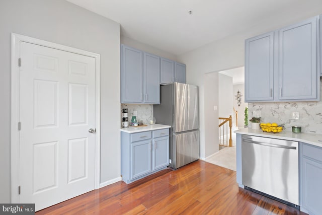 8311 Cloud St, Laurel, MD 20724 - kitchen featuring stainless steel appliances, decorative backsplash, dark wood-style floors, and light countertops