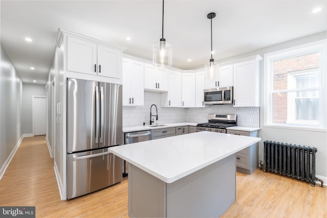 2112 Pine St Unit 2, Philadelphia, PA 19103 - kitchen featuring radiator, appliances with stainless steel finishes, light countertops, tasteful backsplash, and a sink