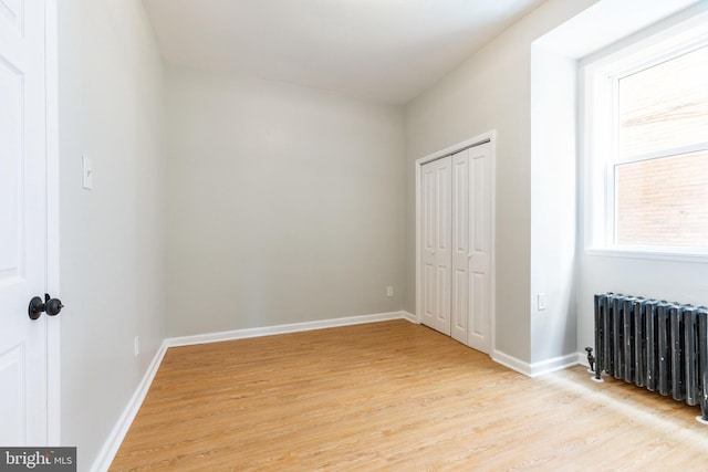 2112 Pine St Unit 2, Philadelphia, PA 19103 - unfurnished bedroom featuring radiator heating unit, light wood-style flooring, baseboards, and a closet