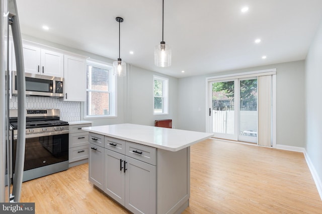 2112 Pine St Unit 2, Philadelphia, PA 19103 - kitchen featuring appliances with stainless steel finishes, light wood-style flooring, light countertops, backsplash, and recessed lighting