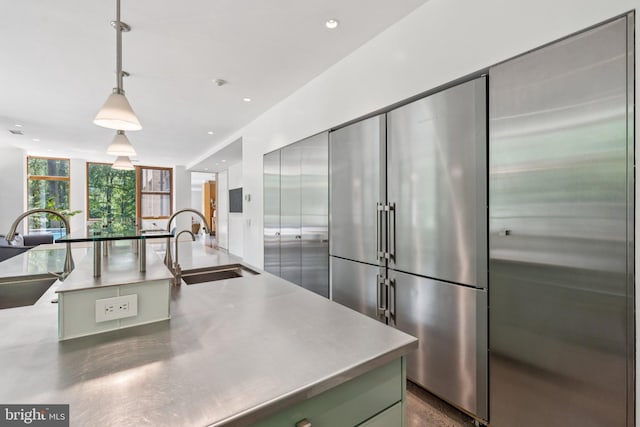 400 Chain Brg, Mclean, VA 22101 - kitchen with stainless steel counters, stainless steel built in fridge, hanging light fixtures, and recessed lighting