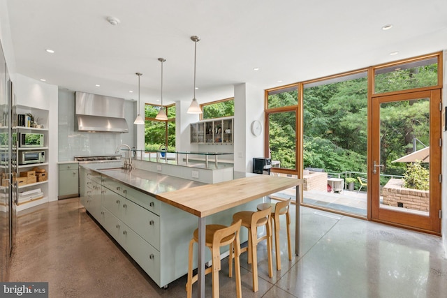 400 Chain Brg, Mclean, VA 22101 - kitchen with wall chimney exhaust hood, finished concrete flooring, decorative backsplash, a large island with sink, and pendant lighting