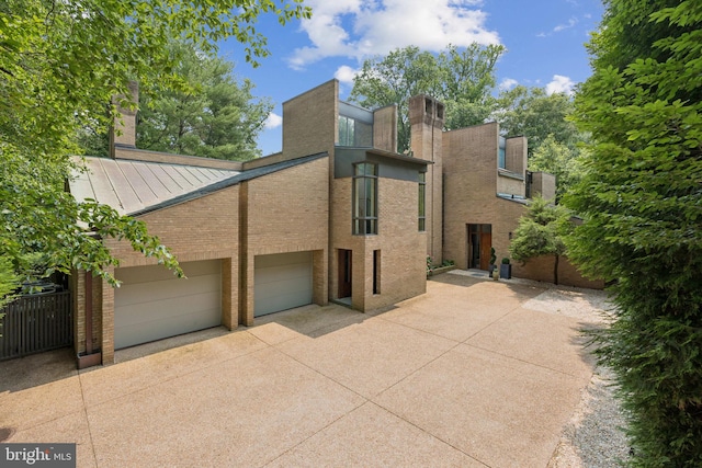 400 Chain Brg, Mclean, VA 22101 - back of property with concrete driveway, brick siding, and a standing seam roof