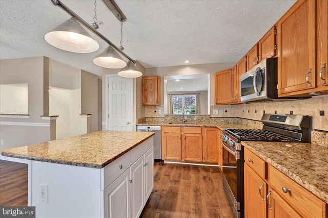 6119 Starburn Path, Columbia, MD 21045 - kitchen with stainless steel appliances, a textured ceiling, dark wood finished floors, backsplash, and a kitchen island