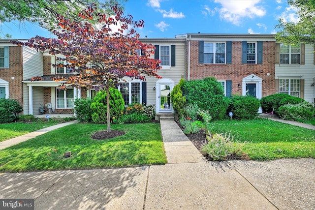 6119 Starburn Path, Columbia, MD 21045 - multi unit property featuring a front yard and brick siding