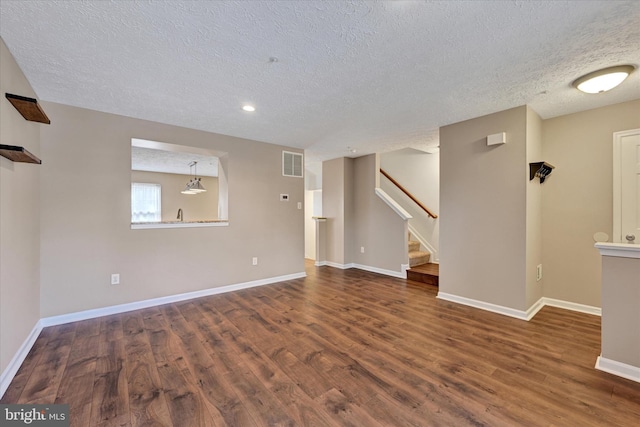 6119 Starburn Path, Columbia, MD 21045 - unfurnished living room with a textured ceiling, wood finished floors, stairway, and recessed lighting