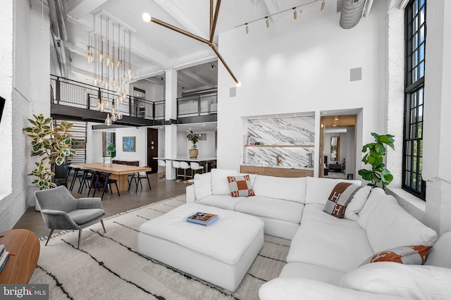1220 Bank St Unit 304, Baltimore, MD 21202 - living area with a high ceiling, a chandelier, and wood finished floors