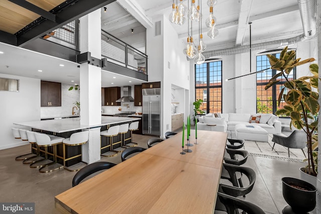 1220 Bank St Unit 304, Baltimore, MD 21202 - dining space with concrete flooring, a high ceiling, beamed ceiling, and baseboards