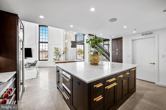1220 Bank St Unit 304, Baltimore, MD 21202 - kitchen with finished concrete flooring, recessed lighting, a kitchen island, and dark brown cabinetry