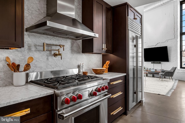 1220 Bank St Unit 304, Baltimore, MD 21202 - kitchen with wall chimney exhaust hood, stainless steel stove, backsplash, and dark brown cabinets