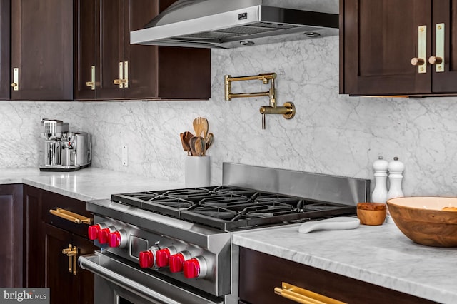 1220 Bank St Unit 304, Baltimore, MD 21202 - kitchen featuring stainless steel stove, ventilation hood, dark brown cabinetry, backsplash, and light stone countertops