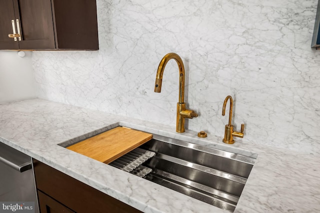 1220 Bank St Unit 304, Baltimore, MD 21202 - kitchen view of a sink, tasteful backsplash, dark brown cabinetry, and light stone counters