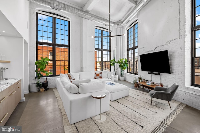 1220 Bank St Unit 304, Baltimore, MD 21202 - living area featuring concrete flooring, a towering ceiling, and beam ceiling