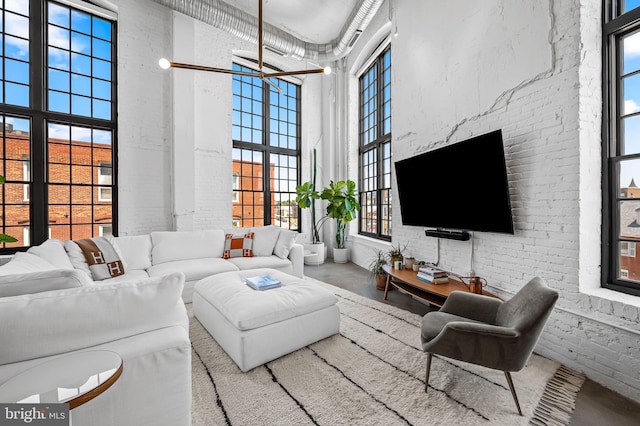 1220 Bank St Unit 304, Baltimore, MD 21202 - living room with a high ceiling and brick wall