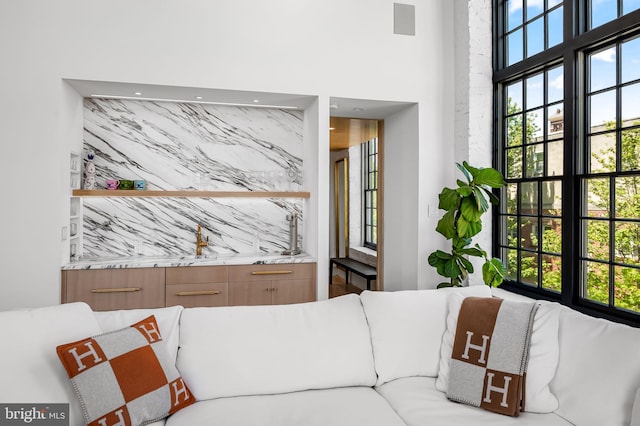 1220 Bank St Unit 304, Baltimore, MD 21202 - living room featuring healthy amount of natural light and a high ceiling