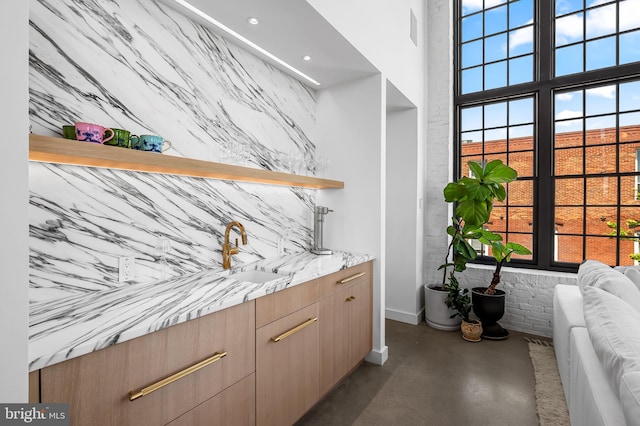 1220 Bank St Unit 304, Baltimore, MD 21202 - bar featuring a sink, finished concrete floors, baseboards, recessed lighting, and a high ceiling