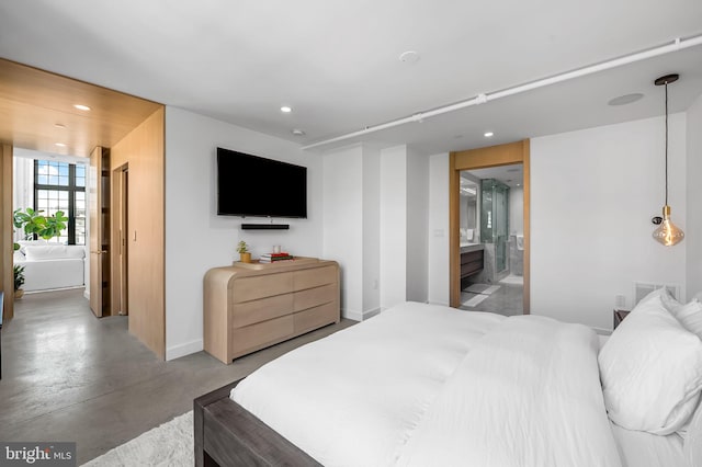 1220 Bank St Unit 304, Baltimore, MD 21202 - bedroom with finished concrete floors, recessed lighting, baseboards, and ensuite bathroom