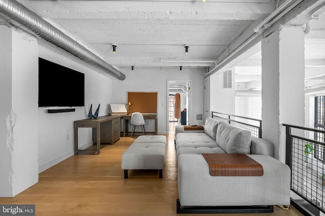 1220 Bank St Unit 304, Baltimore, MD 21202 - living area featuring light wood-style floors, baseboards, and a desk