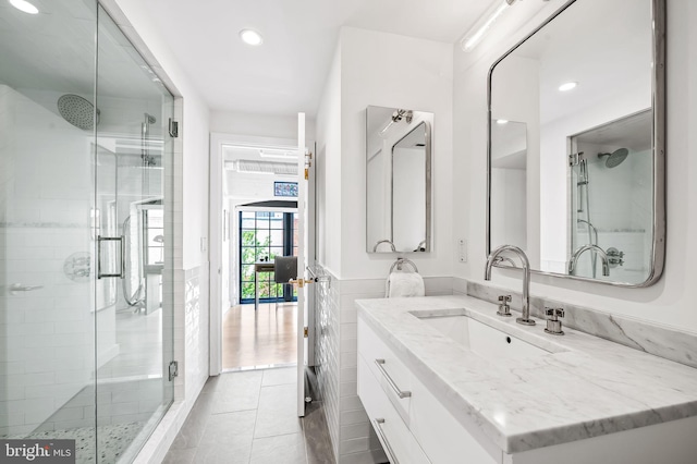 1220 Bank St Unit 304, Baltimore, MD 21202 - full bath with a stall shower, vanity, recessed lighting, tile patterned flooring, and wainscoting