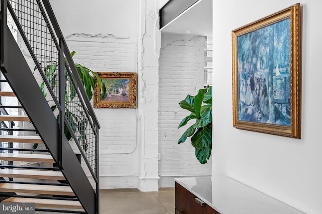 1220 Bank St Unit 304, Baltimore, MD 21202 - stairs featuring brick wall and finished concrete flooring