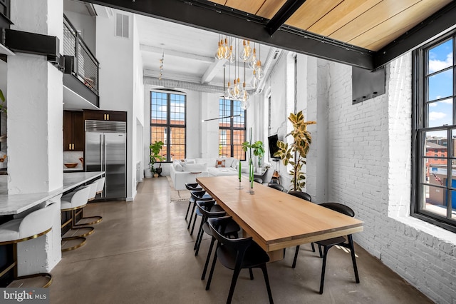 1220 Bank St Unit 304, Baltimore, MD 21202 - dining room with brick wall, concrete flooring, a chandelier, and beamed ceiling
